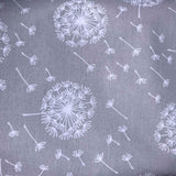 White dandelions on a gray background