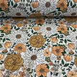 Lieli, brūngani ziedi uz pienbalta pamata, muslīns